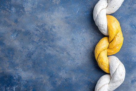 This image features a colorful twisted rope design on a textured blue background, showcasing...