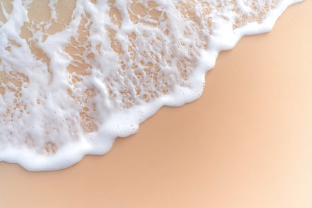 A serene view of gentle waves rolling onto a soft sandy beach, creating foam and subtle water...
