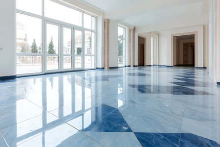 A spacious and bright empty room featuring a glossy blue marble floor and large windows, perfect for showcasing modern design and elegance.の写真素材