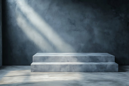 A serene minimalist space features a gray concrete platform illuminated by soft light rays. Perfect for artistic displays, exhibits, or modern interior designs.の写真素材