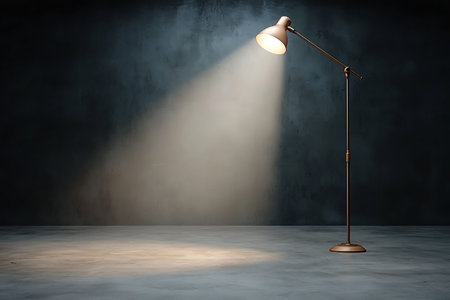 A stylish floor lamp stands in a minimalist space, providing a dramatic spotlight against a dark...
