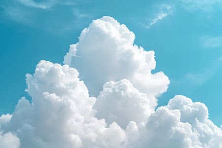 A stunning display of white fluffy clouds set against a bright blue sky, capturing the serene beauty...