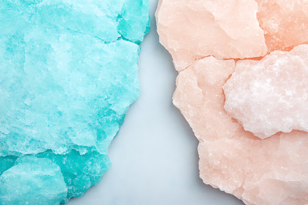 Vibrant pink and blue Himalayan salt crystals arranged on a white surface, ideal for wellness, relaxation, and culinary uses. Add natural beauty to your kitchen or spa.の写真素材