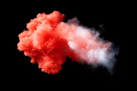 A vibrant red smoke explosion creates captivating visual effects against a black background, providing an abstract and dramatic element ideal for artistic projects.の写真素材