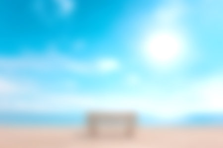 A serene beach scene featuring a soft sandy shore, gentle waves, and a bright blue sky. Perfect for evoking feelings of peace and relaxation.の写真素材