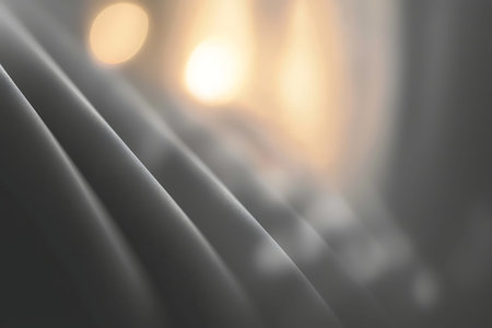 This image features a soft flowing fabric with warm light accents, creating an elegant and artistic...