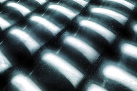 Discover an abstract close-up of a metallic surface featuring intricate light reflections and...