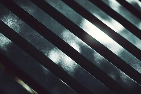 A striking abstract close-up of metal slats arranged at a diagonal angle, capturing soft light and...