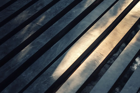 An abstract view showcasing the interplay of shadow and light on metallic strips. The sleek lines...