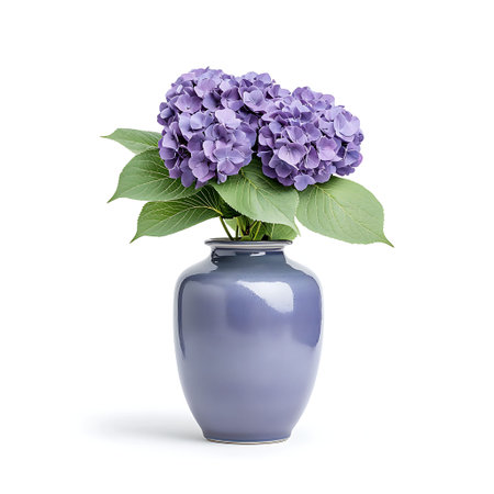 A stunning arrangement of purple hydrangea blooms in a smooth ceramic vase, showcasing natural...