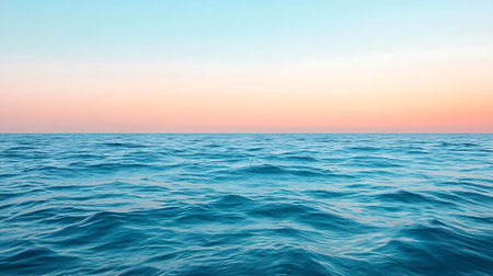 Experience the serene beauty of ocean waves gently flowing under a pastel sunset sky, evoking a...