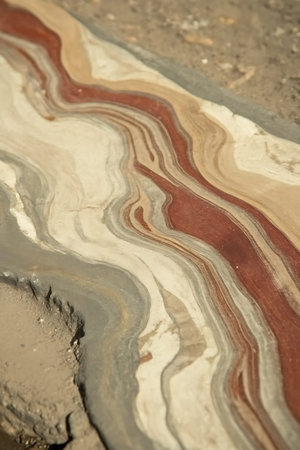 This image showcases a close-up view of a stunning natural stone featuring vibrant stripes and...