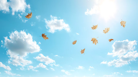 A serene scene of autumn leaves drifting gracefully through a bright blue sky filled with fluffy...