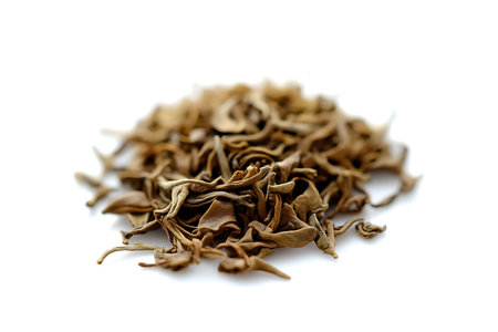 A close-up of dried herbal leaves arranged attractively on a pure white background. Ideal for...