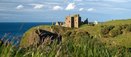 Clifftop ruins of Dunottar Castle on a sunny dayの写真素材