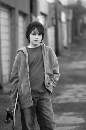 Moody skateboarder in an alleyway, black and whiteの写真素材