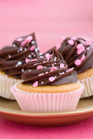 Trio of pink chocolate cupcakes on a plateの写真素材