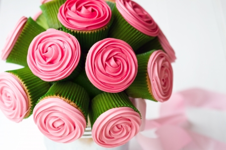 Bouquet of rose cupcakes tied with a ribbonの写真素材