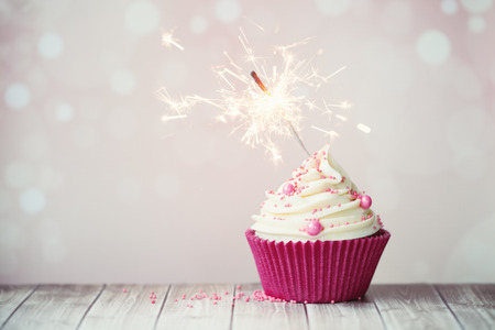 Pink birthday cupcake with sparklerの写真素材