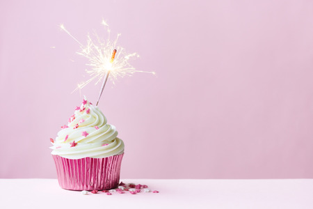 Pink cupcake decorated with a sparklerの写真素材