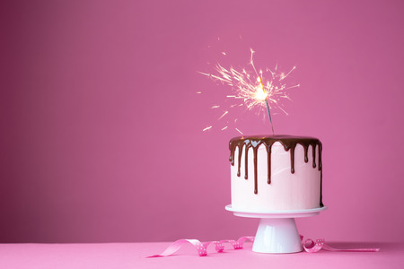 Cake decorated with a sparklerの写真素材
