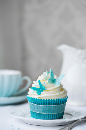 Cupcake decorated with sugarpaste butterfliesの写真素材