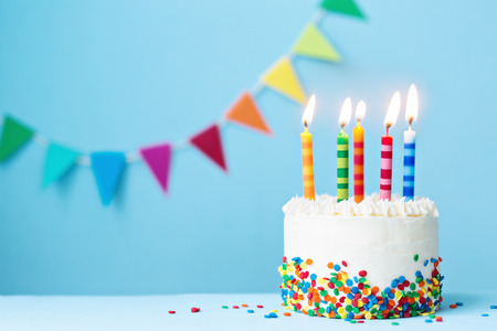 Birthday cake with colorful candlesの写真素材