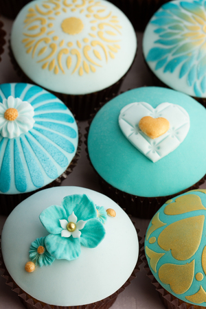 Wedding cupcakes in gold and tealの写真素材