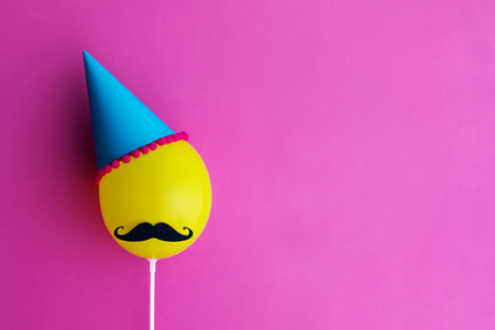 Birthday party balloon with party hat and moustacheの写真素材