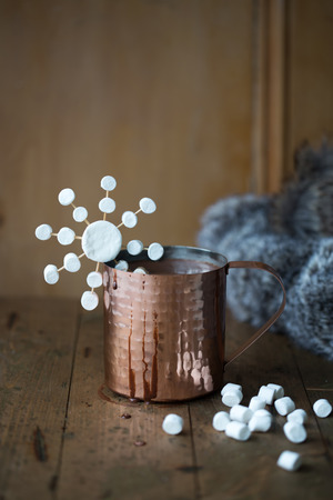 Hot chocolate in a copper mug with marshmallowsの写真素材