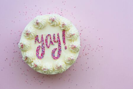 Birthday cake with yay written in colorful sprinklesの写真素材