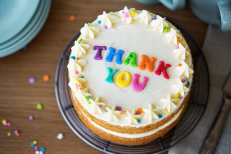 Cake with colorful rainbow letters spelling thank you