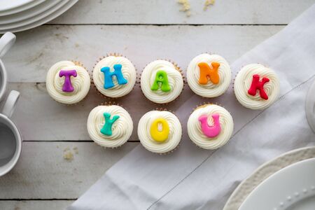 Cupcakes with thank you written in rainbow colorsの写真素材