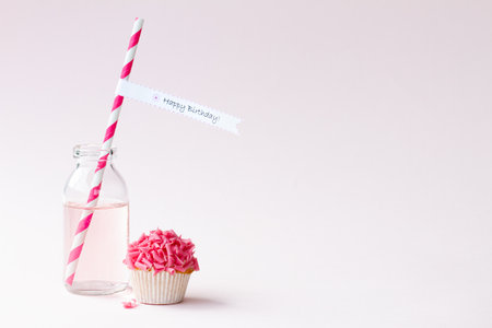 Birthday party background with cupcake and pink lemonadeの写真素材