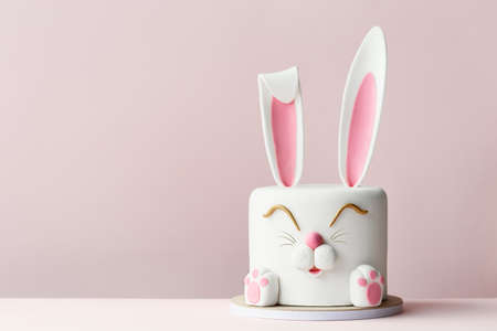Easter bunny celebration cake on a pink backgroundの写真素材