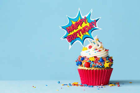 Celebration birthday cupcake with superhero happy birthday cake pickの写真素材