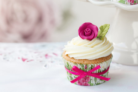 Cupcake decorated with a pink sugar roseの写真素材
