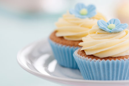 Cupcakes decorated with blue sugar flowersの写真素材