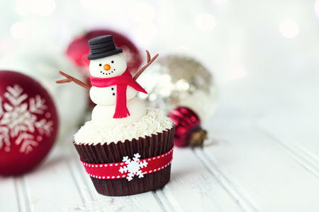 Chrismas cupcake decorated with a fondant snowmanの写真素材