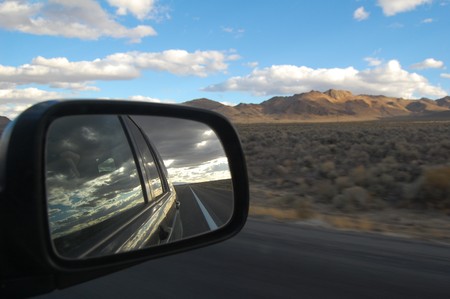 landscape view from car mirror while traveling in nevadaの写真素材