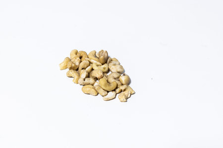 a pile of cashew nuts stacked on a white table. Protein superfood or healthy snack.