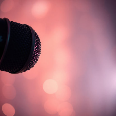 Close-up of a microphone against a bokeh background. Perfect for music, podcasting, or performance themes.の素材