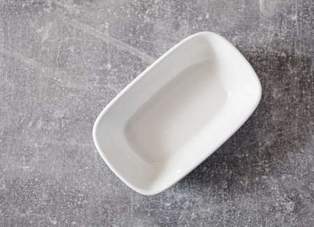 empty white bowl on gray table, top viewの写真素材