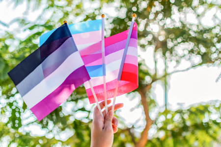 Female hand hold asexual, transgender and lesbian flag. Select focus. Genderqueer.