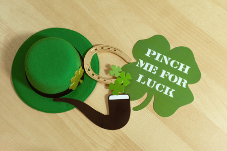 Flat lay composition with clover leaves, green hat and horseshoe on wooden background. St. Patrick's day.の写真素材