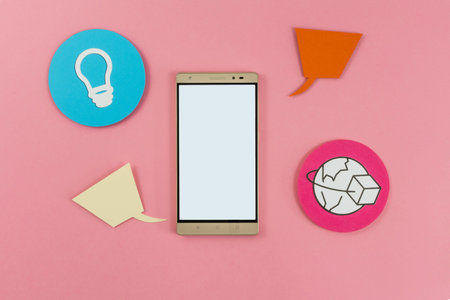 Tablet with white screen, along with icons made on paper, different applications for cell phones and...