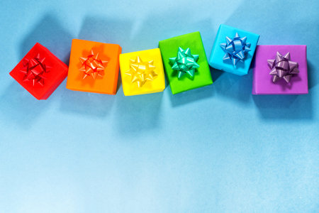 gifts with the colors of LGBT on blue background. Valentines day card concept. Heart for Valentines...