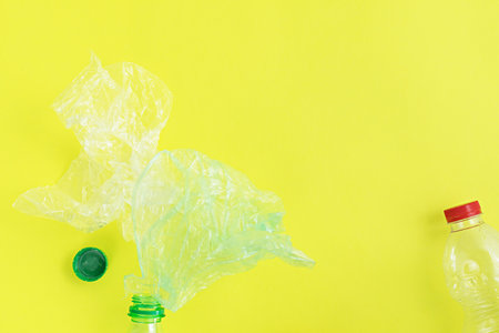 Top view of plastic objects for recycling on a yellow background.の写真素材