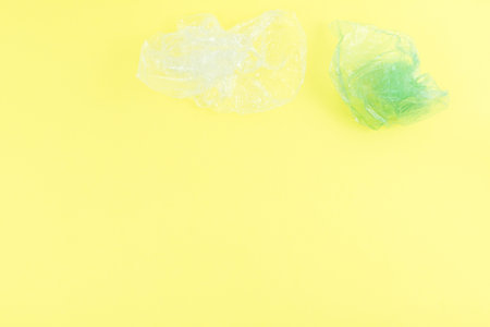 Top view of plastic objects for recycling on a yellow background.の写真素材