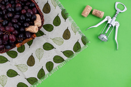 grapes and bottle of wine on green background. zenith view. cork and uncover cork.の写真素材